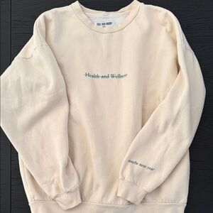 CAll Her Daddy Cream Sweatshirt with Green Text “health and wellness” lined out